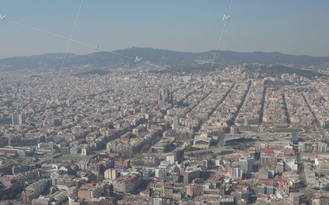 AERIAL: Barcelona Wide Drone Shot of City Towards Center with La Sagrada Familia and Torre Glories